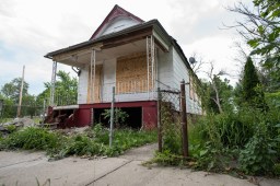 Over the past decade, Norfolk Southern has been buying up houses in this section of Englewood and demolishing them. Here, a boarded up house at 517 W. 57th Street is seen on June 20, 2015. (Photo by Max Herman)