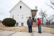 Margaret Bonnett and her grandson, Malik, stand in front of her house on West 57th Place, which has been in her family since 1953. Bonnett says before 2011, when Norfolk Southern announced plans to expand its intermodal rail yard south of Garfield Boulevard, most people in the neighborhood didn't think twice about the railroad's presence. (Photo by Max Herman)