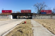 A freight train rolls by the largely vacant 84-acre site Norfolk Southern is using to expand its intermodal rail yard. (Photo by Max Herman)