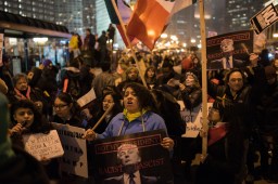 "Racist, sexist, anti-gay! Donald Trump, go away!" a crowd chants outside of Trump Tower in downtown Chicago on Inauguration Day.