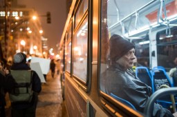 A man riding a CTA bus watches as demonstrators march in River North protesting Donald Trump's inauguration on Jan. 20, 2017.