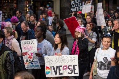 Participants carry signs championing a range of causes during the Women’s March on Chicago.