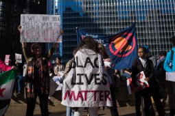 A participant of the Women’s March on Chicago displays a “Black Lives Matter” sign in front of Trump Tower.